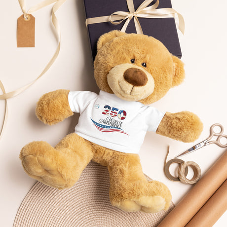 Soft plush teddy bear and gift items including a wrapped box, scissors, and wrapping paper